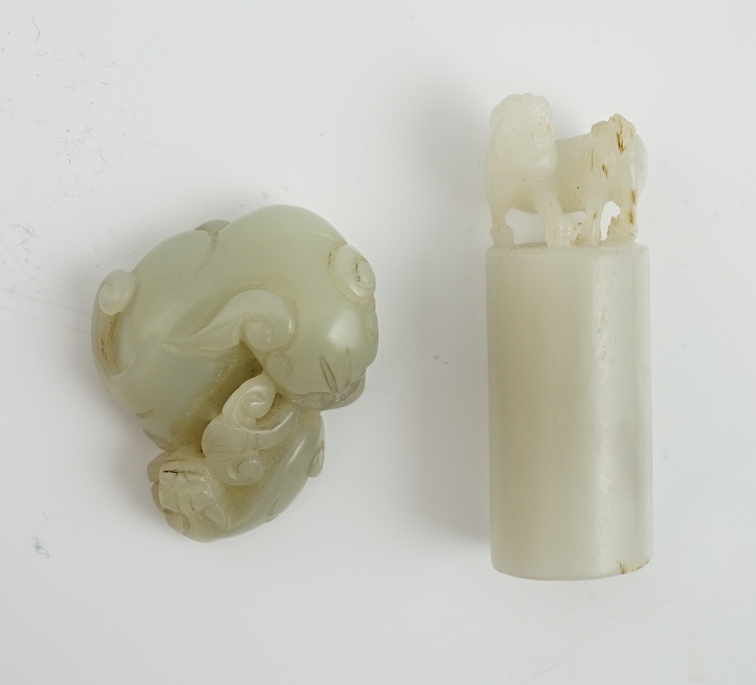 A Chinese white jade lion-dog seal and a Chinese pale celadon jade group of a lion dog and cub, 19th century